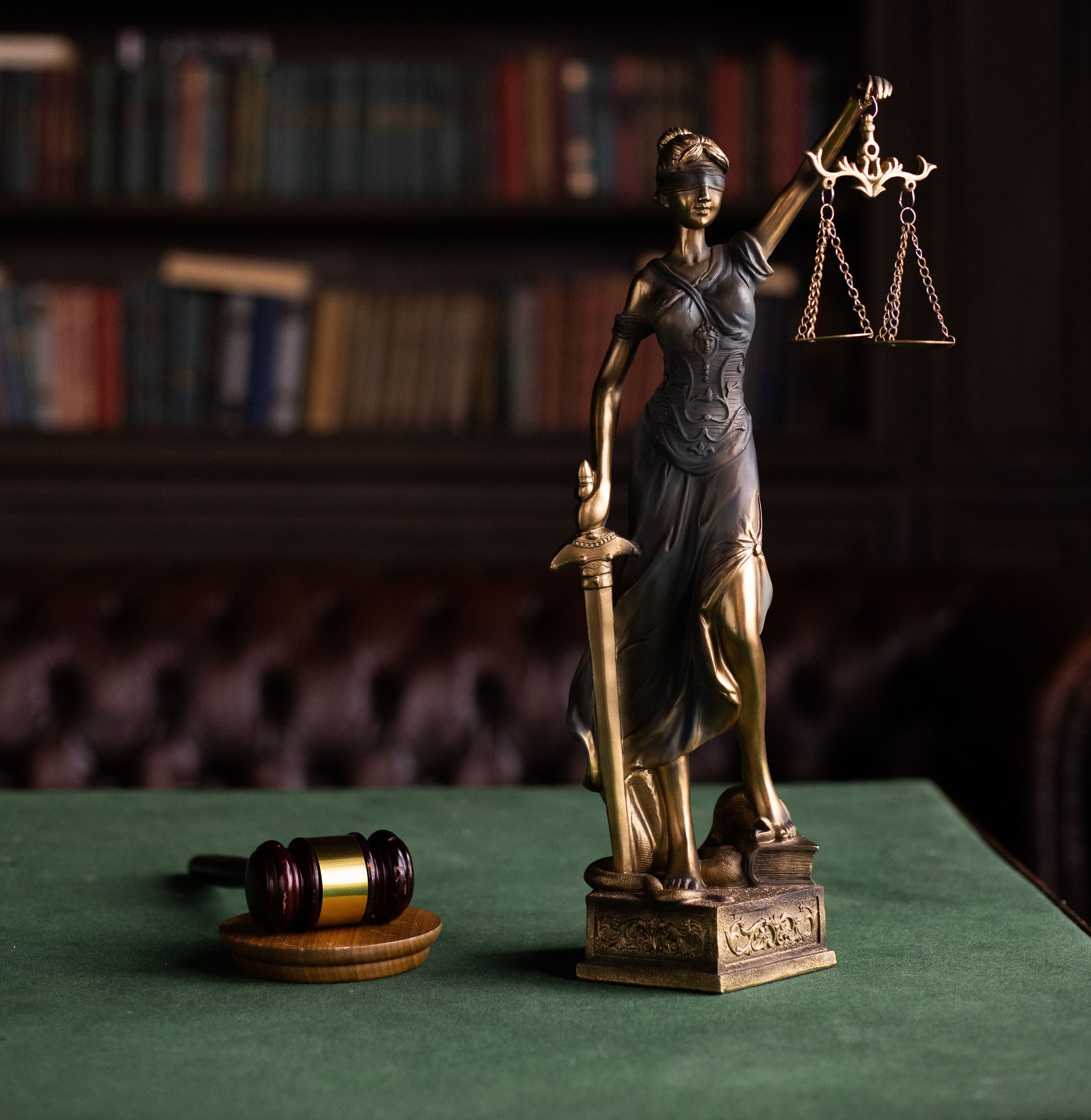 A figure of justice beside law books